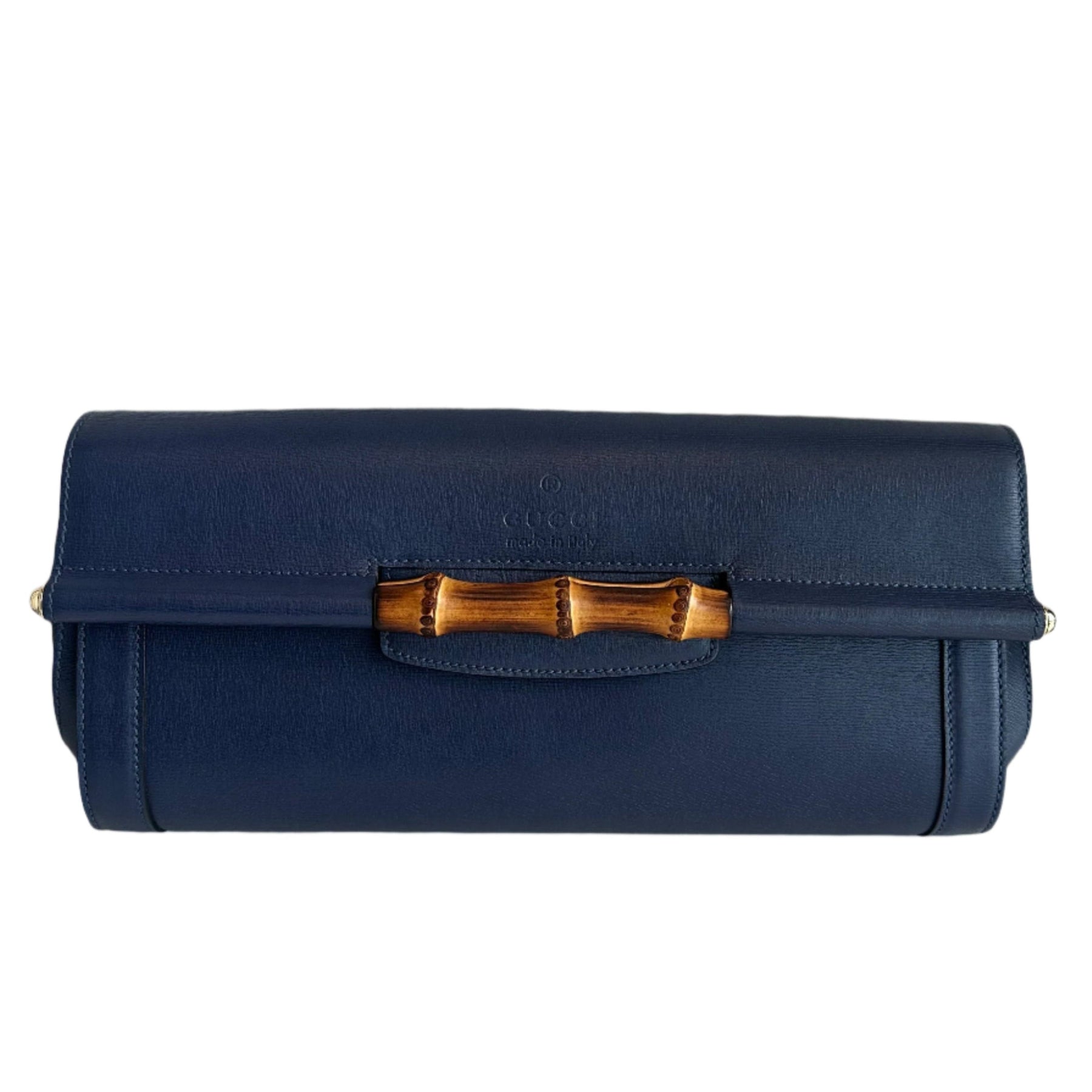 Gucci Bamboo Clutch
Blue Leather
Bamboo Accent
Single Exterior Pocket
Nylon Lining
Dual Interior Pockets with Card Slots
Snap Closure 