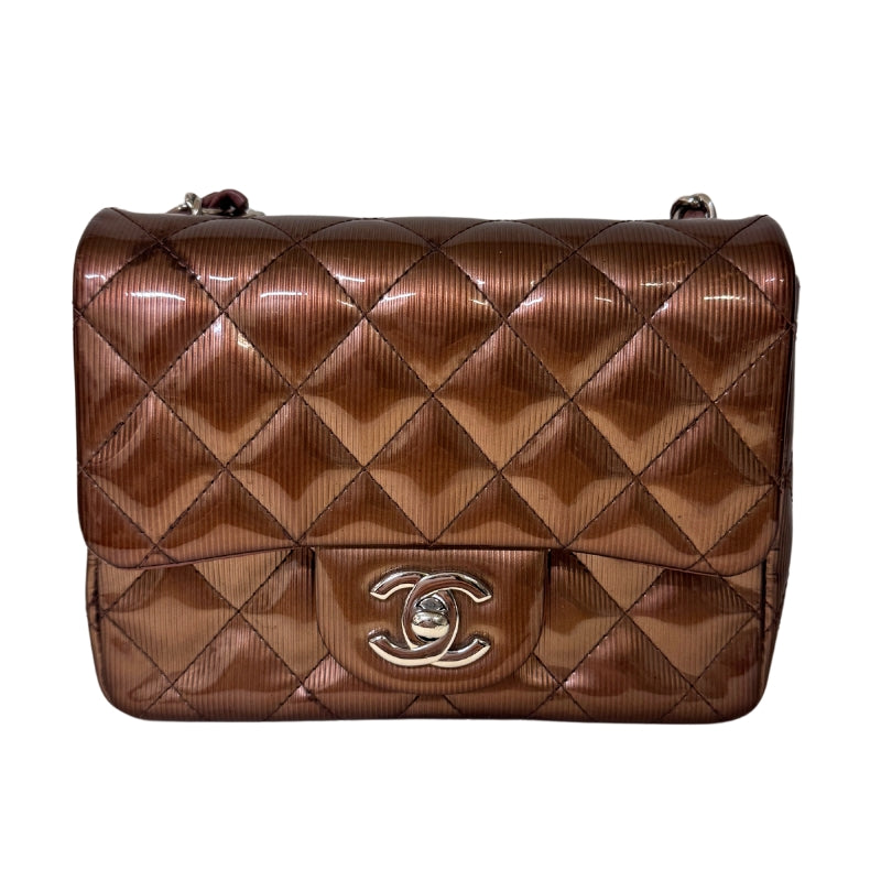 Chanel Patent Quilted Mini 
Diamond Quilted Patent Leather 
Bronze Color 
Vertical Stripes Pattern
Rear Pocket 
Long Silver Chain Link 
Front Flap
CC Lock Closure 
Matte Leather Interior 