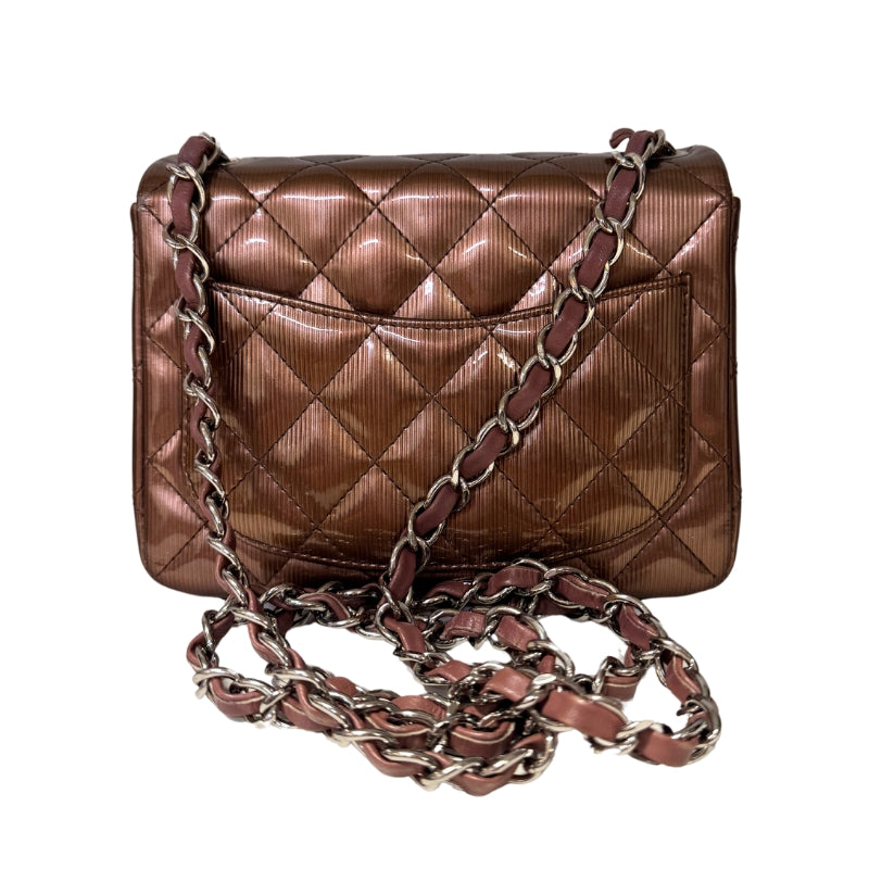 Chanel Patent Quilted Mini 
Diamond Quilted Patent Leather 
Bronze Color 
Vertical Stripes Pattern
Rear Pocket 
Long Silver Chain Link 
Front Flap
CC Lock Closure 
Matte Leather Interior 