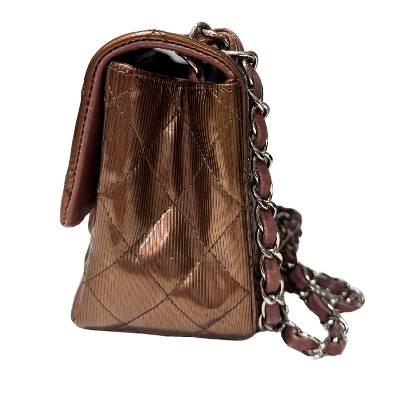 Chanel Patent Quilted Mini 
Diamond Quilted Patent Leather 
Bronze Color 
Vertical Stripes Pattern
Rear Pocket 
Long Silver Chain Link 
Front Flap
CC Lock Closure 
Matte Leather Interior 