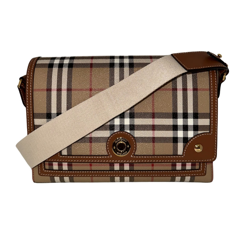 Burberry Note Bag   Textured Plaid Exterior  Brown Leather Features  Gold-Toned Hardware  White Canvas Strap   Magnetic Button Closure   Adjustable Strap 