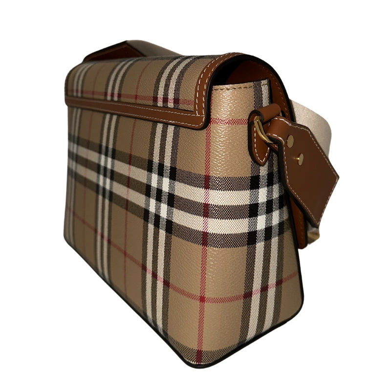 Burberry Note Bag   Textured Plaid Exterior  Brown Leather Features  Gold-Toned Hardware  White Canvas Strap   Magnetic Button Closure   Adjustable Strap 