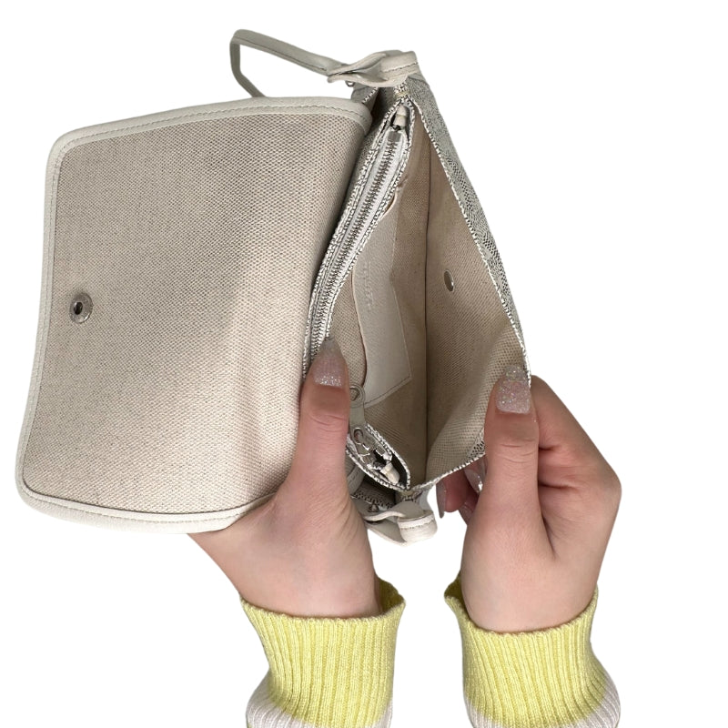 Goyard Plummet Clutch White Printed Goyardine Silver-Toned Hardware Single Shoulder Strap Single Exterior Pocket Canvas Lining Snap Closure at Front Zip Pocket in Interior Two Interior Card Pockets