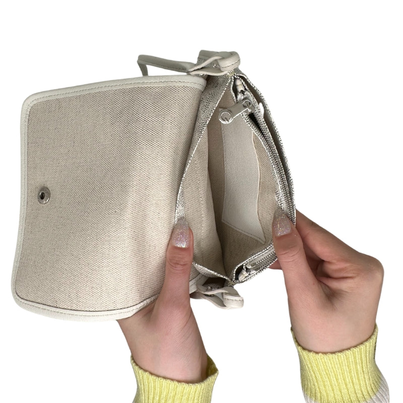 Goyard Plummet Clutch White Printed Goyardine Silver-Toned Hardware Single Shoulder Strap Single Exterior Pocket Canvas Lining Snap Closure at Front Zip Pocket in Interior Two Interior Card Pockets