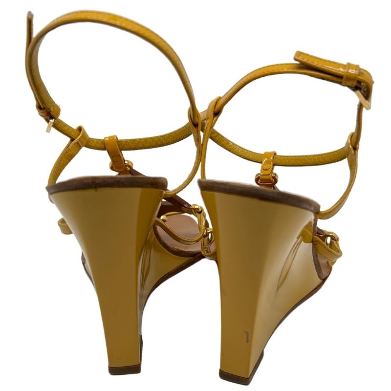Louis Vuitton Wedge Sandals, Size: 38.5, Yellow Patent Leather, Tan Brown Leather, Fully Lined, Wedges Sandals, Flower Cut Outs, Buckle Closure, Leather Soles and Insoles, Heel Height: 10". Condition: Excellent.