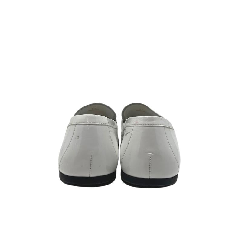 Prada white patent leather loafers, gold and white metal prada logo on front, white patent leather exterior, szie 38, rubber sole, penny loafer style, condition good with some exterior scuffs