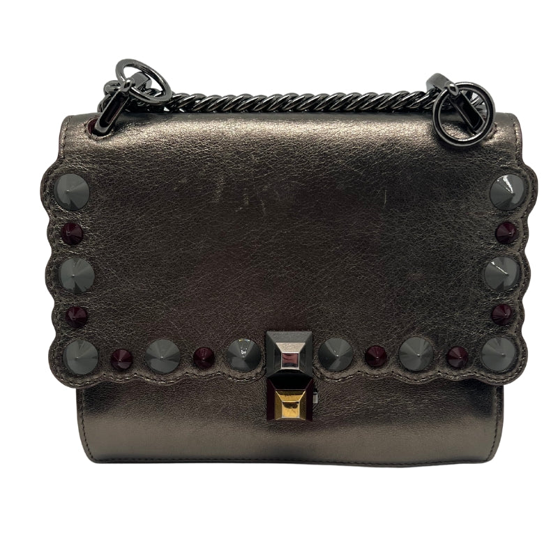 Front View: Metallic Leather, Metallic Hardware, Chain Link Shoulder Strap, Studded Accents, Maroon Trim, Push-Lock Closure at Front.