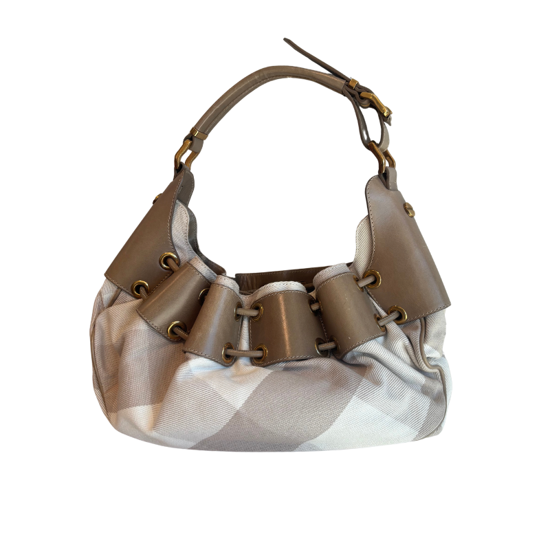 A slouchy shoulder bag with a beige and white check pattern body, brown leather trim, and gold-tone hardware, shown against a plain white background.