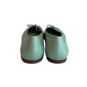 A pair of mint green leather lace-up shoes shown from the back, featuring a smooth finish and brown soles, set against a plain white background.