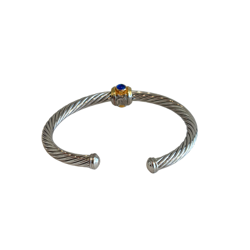 Back of silver David Yurman Renaissance Cable Bracelet with gold accents and a blue stone on a white background. 