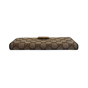 Base of Gucci Canvas Icon Bar Monogram Flap Wallet on a White Background. 