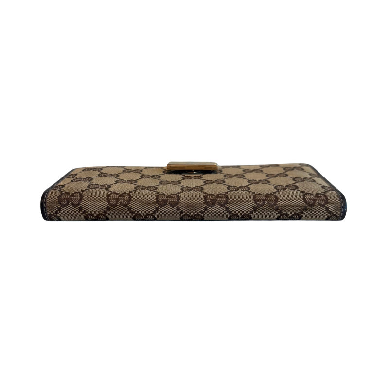 Base of Gucci Canvas Icon Bar Monogram Flap Wallet on a White Background. 