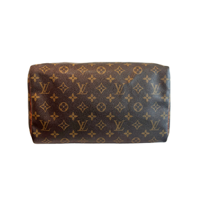 Base of Louis Vuitton Monogram Speedy 30 Boston Bag on a White Background. 