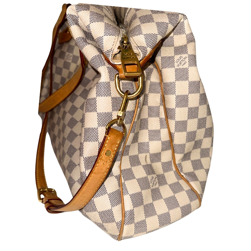 Louis Vuitton Damier Azur Evora GM  Neutral Coated Canvas&nbsp;  Gold-Toned Hardware&nbsp;  Leather Trim Embellishments&nbsp;  Flat Handles&nbsp;  Dual Shoulder Straps  Adjustable Shoulder Strap&nbsp;  Jacquard Lining&nbsp;  Single Interior Pocket&nbsp;  Zipper Closure at Top&nbsp;  Zipper Pocket on Exterior&nbsp;