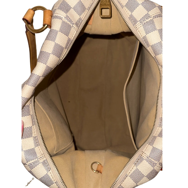 Louis Vuitton Damier Azur Evora GM  Neutral Coated Canvas&nbsp;  Gold-Toned Hardware&nbsp;  Leather Trim Embellishments&nbsp;  Flat Handles&nbsp;  Dual Shoulder Straps  Adjustable Shoulder Strap&nbsp;  Jacquard Lining&nbsp;  Single Interior Pocket&nbsp;  Zipper Closure at Top&nbsp;  Zipper Pocket on Exterior&nbsp;