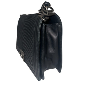 Chanel Black Boy Bag&nbsp;  Black Lambskin&nbsp;  Interlocking&nbsp;CC Logo  Chevron Pattern  Silver-Toned Accents&nbsp;  Chain Link Strap Accent  Push Lock Closure at Front&nbsp;  Grosgrain Lining Interior&nbsp;  Interior Pocket&nbsp;  Condition: Great, minor scratches on inside flap&nbsp;