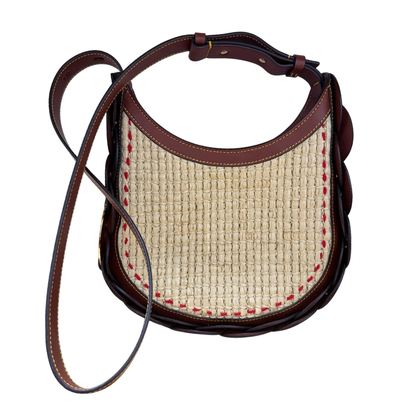Chloe Raffia Darryl Hobo&nbsp;

Brown Calfskin Leather&nbsp;

Raffia

Looping Leather Shoulder Strap

Gold-Toned Ring&nbsp;

Beige Fabric Interior&nbsp;