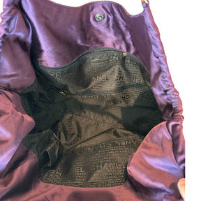 Chanel Coco Cabas XL&nbsp;

Purple Satin&nbsp;

Gold-Toned Hardware

CC Logo Charm&nbsp;

Leather Shoulder Handles

Fabric Lined Interior&nbsp;