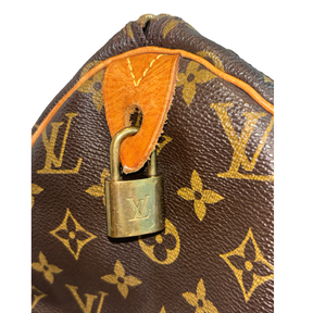Close Up of Leather Tab and Locket on Louis Vuitton Monogram Speedy 30 Boston Bag.