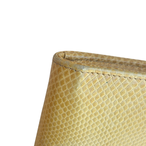 Close Up of Wear on Yellow Miu Miu Leather Zip Around Wallet on a White Background. 