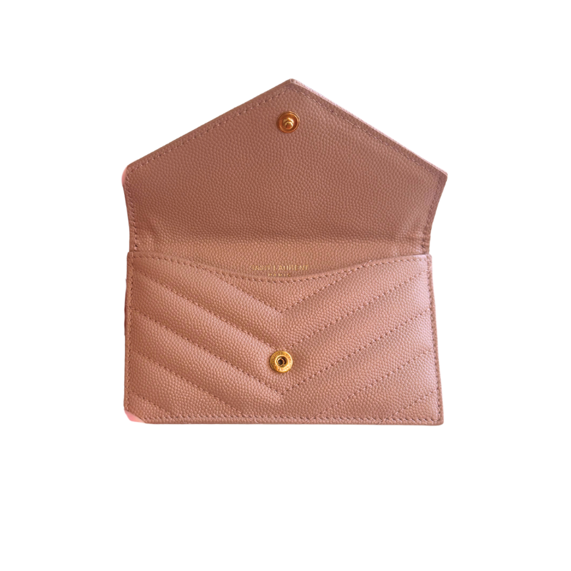 A blush pink pebbled leather card holder with a chevron quilted front pocket and gold-tone snap buttons, shown open against a plain white background.