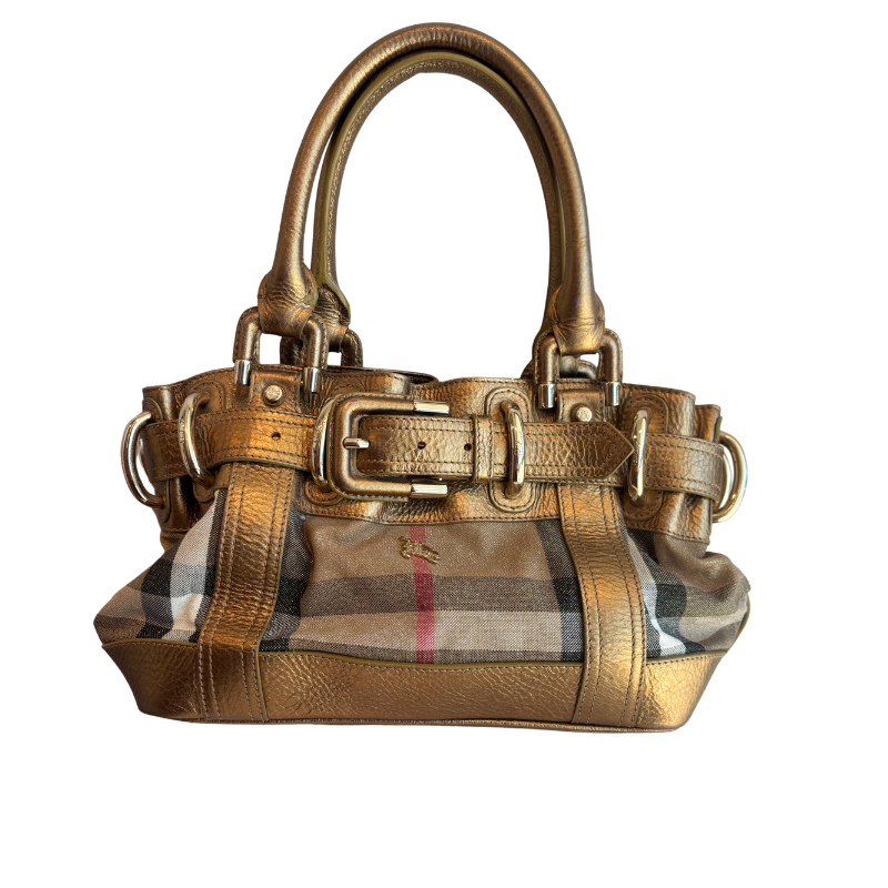 A metallic gold leather handbag with double top handles, decorative buckle straps, and a front panel featuring the classic Burberry check pattern in beige, brown, black, and red.