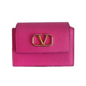 A bright pink textured leather wallet with a gold-tone metal 'V' logo clasp, shown against a plain white background.