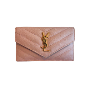 A Saint Laurent pouch in light pink pebbled leather with a gold-tone YSL logo clasp, shown against a plain white background.