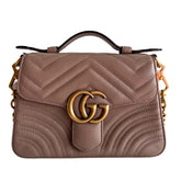 Gucci Marmont Top Handle Bag&nbsp;

Beige Matelassé&nbsp;

Chevron-Quilted Leather&nbsp;

Gold-Toned Hardware

GG Logo

Chain Link Shoulder Strap&nbsp;

Front Crossover Flap&nbsp;