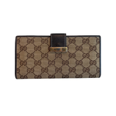 Front of Brown Gucci Canvas Icon Bar Monogram Flap Wallet on a White Background. 