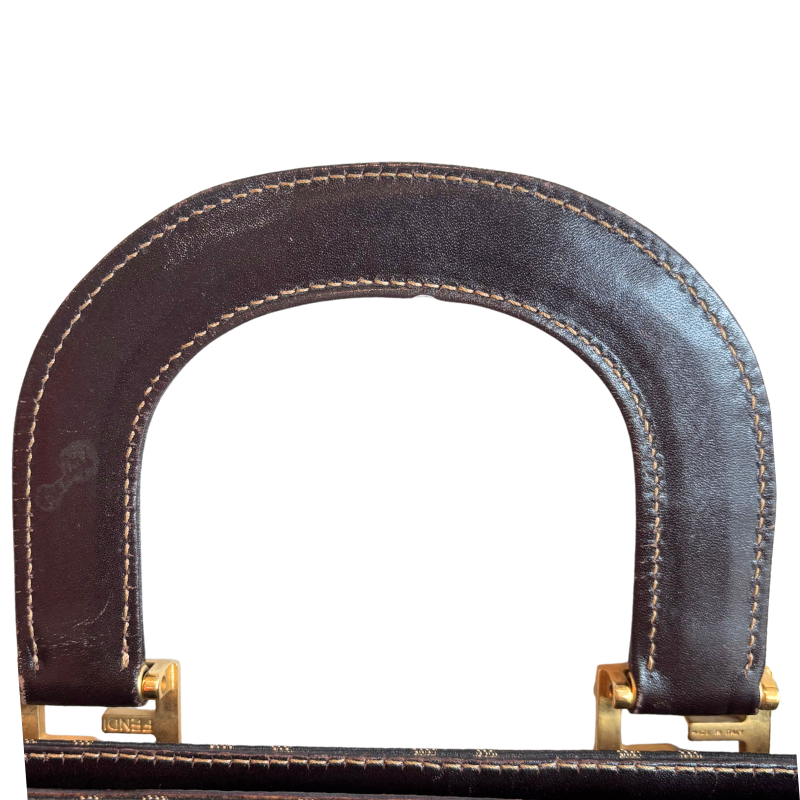 Inner Side of Handle Damage on the Fendi Zucca FF Canvas Tote. Pictured on a white background. 