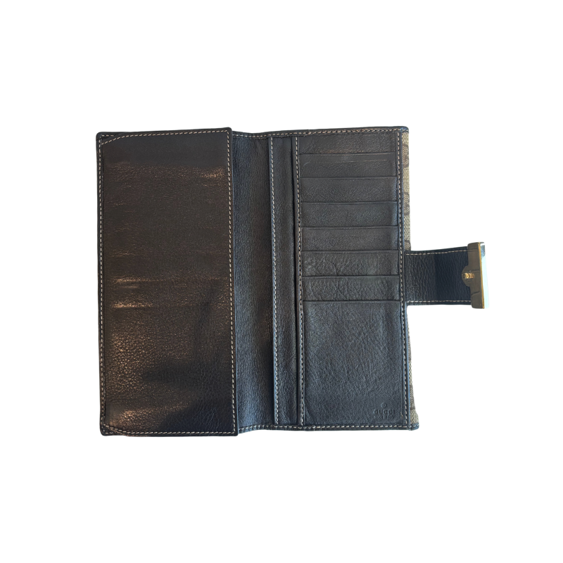 Interior of Brown Gucci Canvas Icon Bar Monogram Flap Wallet on a White Background. 