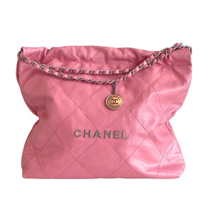 Chanel 22 Handbag Pink Quilted Lambskin Exterior Sliver Toned Hardware Chanel Emblem on Front Exterior Three Magnetic Button Closures Double Chain Shoulder Straps Chanel Charm Attached to One Strap Pink Quilted Fabric Interior Single Interior Flat Pocket Detachable Interior Wallet with Pink Leather Exterior and Quilted Fabric Interior