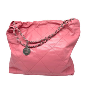 Chanel 22 Handbag Pink Quilted Lambskin Exterior Sliver Toned Hardware Chanel Emblem on Front Exterior Three Magnetic Button Closures Double Chain Shoulder Straps Chanel Charm Attached to One Strap Pink Quilted Fabric Interior Single Interior Flat Pocket Detachable Interior Wallet with Pink Leather Exterior and Quilted Fabric Interior