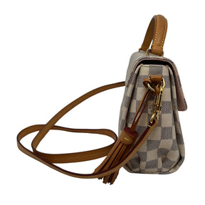 Top Handle Bag Neutral Coated Damier Azur Pattern Gold-Toned Hardware Leather and Tassel Accents Flat Handle & Single Shoulder Strap Canvas Lining & Single Interior Pocket Push-Lock Closure at Front Includes Dust Bag 