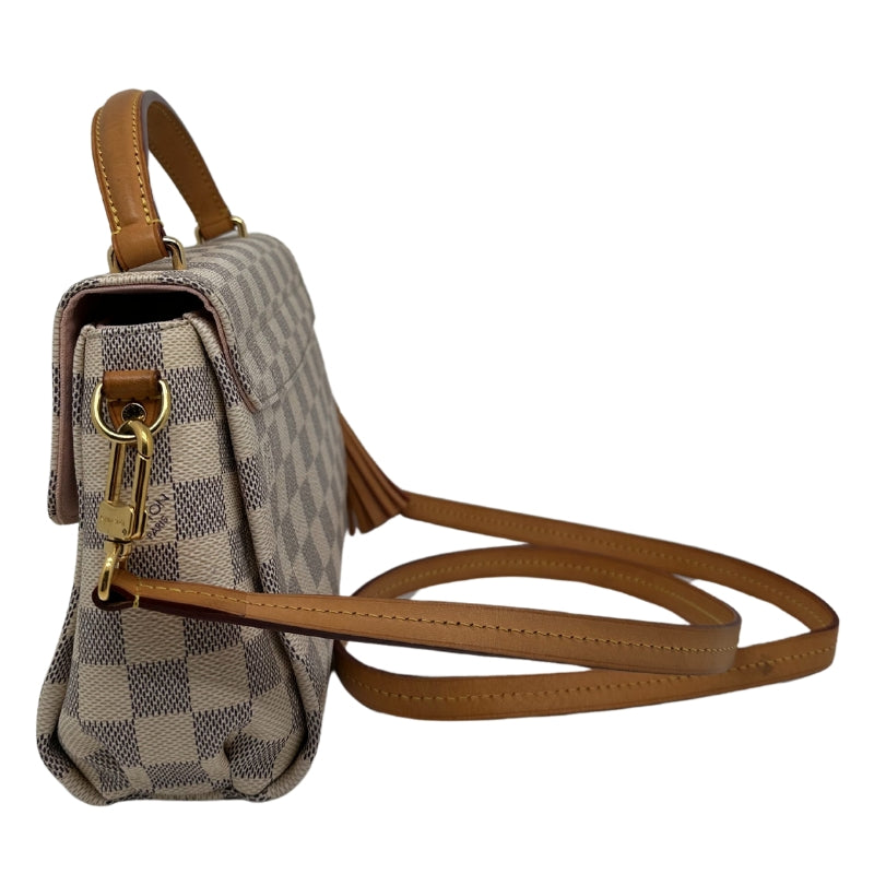 Top Handle Bag Neutral Coated Damier Azur Pattern Gold-Toned Hardware Leather and Tassel Accents Flat Handle & Single Shoulder Strap Canvas Lining & Single Interior Pocket Push-Lock Closure at Front Includes Dust Bag 