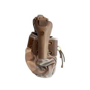 A brown leather and canvas shoulder bag with brass-tone hardware, shown against a plain white background.