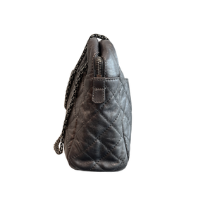 Left Side of Chanel Quilted Calfskin Leather Medium Reissue Camera Bag on a white background. 