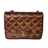 Chanel Patent Quilted Mini&nbsp;

Diamond Quilted Patent Leather&nbsp;

Bronze Color&nbsp;

Vertical Stripes Pattern

Rear Pocket&nbsp;

Long Silver Chain Link&nbsp;

Front Flap

CC Lock Closure&nbsp;

Matte Leather Interior&nbsp;