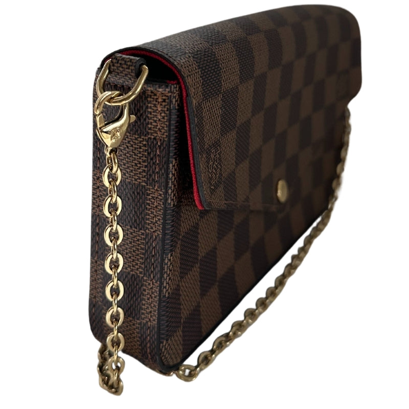 Louis Vuitton Felecie Pochette&nbsp;

Louis Vuitton Shoulder Bag

Brown Coated Canvas

Damier Ebene Pattern

Brass Hardware

Chain-Link Shoulder Strap&nbsp;

Canvas Lining&nbsp;

Detatchable Interior Pouch and Cardholder&nbsp;