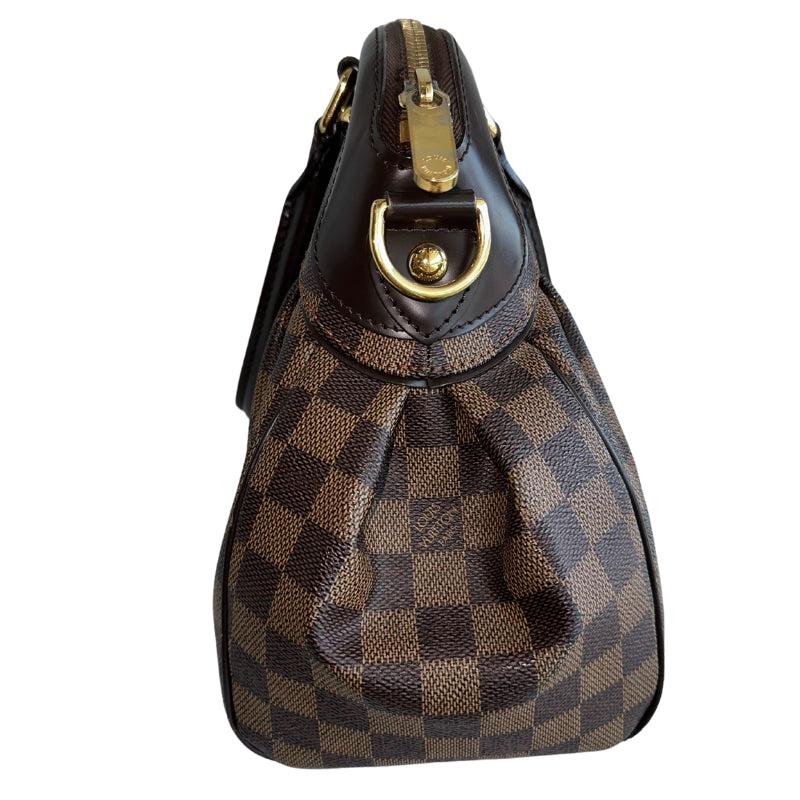 Louis Vuitton Trevi DB&nbsp;  Louis Vuitton Damier Coated Canvas  Brown Canvas  Gold-Toned Hardware  Rolled Handles  Brown Cowhide Leather Trim&nbsp;  Optional Shoulder Strap&nbsp;