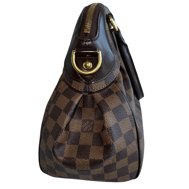 Louis Vuitton Trevi DB&nbsp;  Louis Vuitton Damier Coated Canvas  Brown Canvas  Gold-Toned Hardware  Rolled Handles  Brown Cowhide Leather Trim&nbsp;  Optional Shoulder Strap&nbsp;