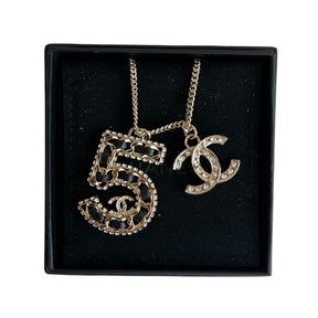 Chanel 5 Necklace&nbsp;

Silver

5 Charm

CC Charm

Black and Diamon Detailing&nbsp;

Clasp&nbsp;

Length: 14"&nbsp;