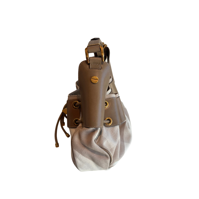 A brown and beige shoulder bag with gold-tone hardware, featuring a structured brown leather strap section and a textured beige mesh body, shown against a plain white background.