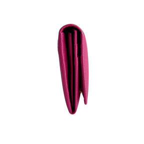 A folded magenta pink textured leather wallet shown from the side, featuring a pebbled leather finish, set against a plain white background.