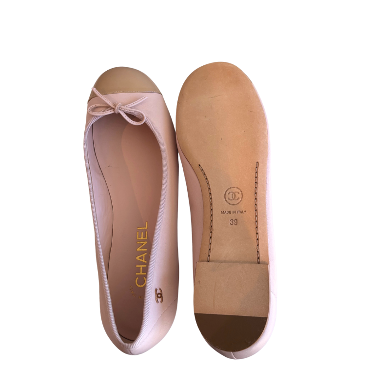A pair of Chanel ballet flats in pale pink, shown from the top and sole views on a white background.