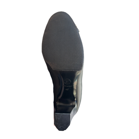 Sole of Chanel Interlocking CC Metal Cap Toe Knee-High Leather Boots on a White Background 