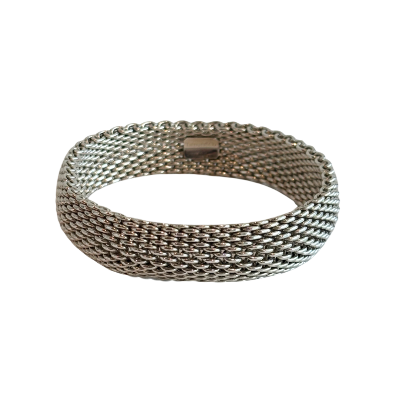 A silver-toned metal mesh bangle bracelet with a woven, textured pattern, shown on a plain white background.