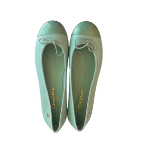 A pair of Chanel ballet flats in a glossy mint green patent leather, shown from a top-down view on a plain white background.