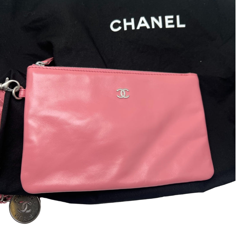 Chanel 22 Handbag  Pink Quilted Lambskin Exterior   Sliver Toned Hardware  Chanel Emblem on Front Exterior   Three Magnetic Button Closures   Double Chain Shoulder Straps  Chanel Charm Attached to One Strap   Pink Quilted Fabric Interior   Single Interior Flat Pocket   Detachable Interior Wallet with Pink Leather Exterior and Quilted Fabric Interior 